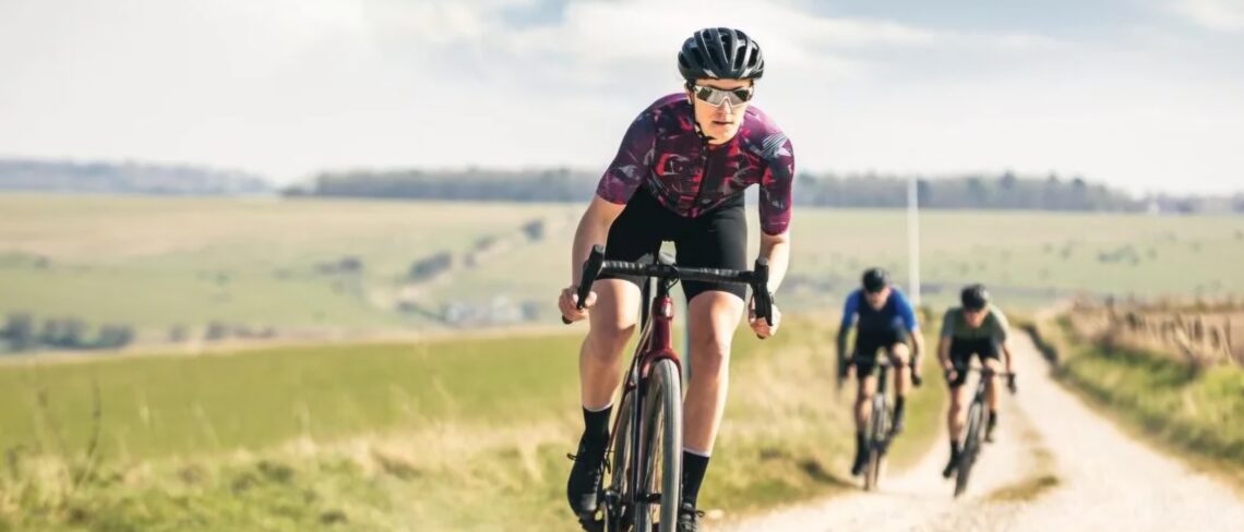 Cyclists riding gravel track